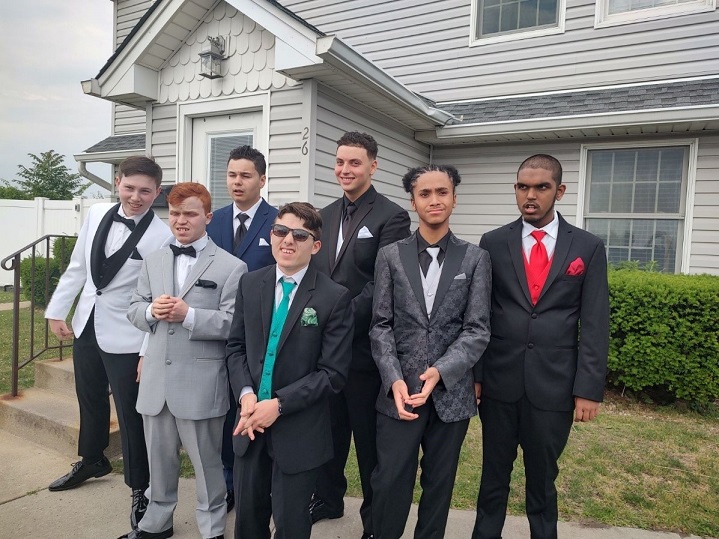 Students pose for a photo in their prom outfits