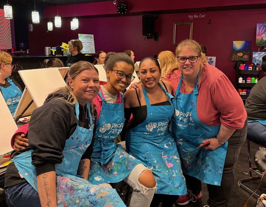 4 members of the Marcus Avenue Parent Association pose for a photo at Paint and Sip