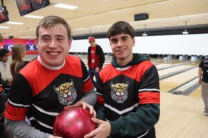 Noah and his brother hold a bowling ball.