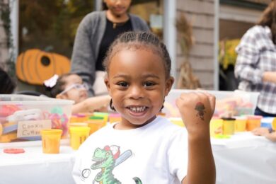 A Children's Education Center student shows off the temporary tattoo on his hand.