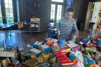 A BCCS student sorts food for the Thanksgiving food drive